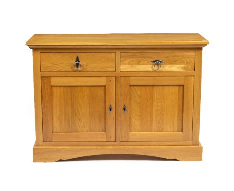 A MODERN LIGHT OAK SIDE CABINET by Frank Hudson, having two drawers above two panelled doors and raised on a plinth base, 121