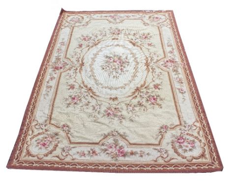 AN AUBUSSON NEEDLEPOINT CARPET with floral decoration, 144cm x 244cm Condition: moth damage to the edges and signs of moth in