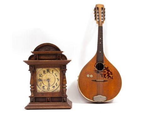 A MANDOLIN 63cm long overall together with Continental walnut mantle clock, 36.5cm high (2) Condition: the mandolin with wear