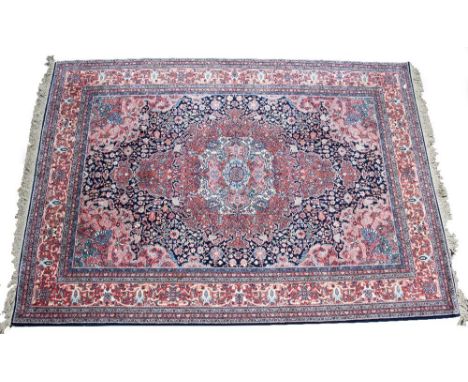 AN AMERICAN MADE PERSIAN STYLE SMALL CARPET with styalised foliate decoration and a banded border, 262cm x 377cm At present, 