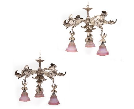 A PAIR OF LATE 20TH CENTURY PRESSED METAL HANGING LIGHT FITTINGS of naturalistic form, each with three opalescent purple glas