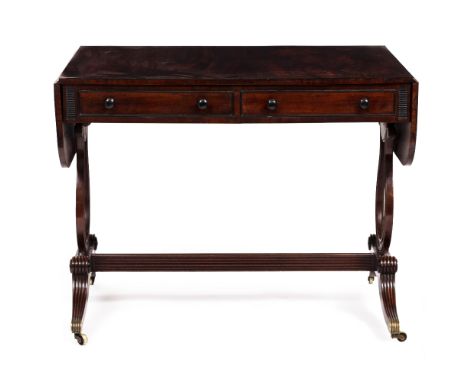 A REGENCY MAHOGANY AND EBONY INLAID SOFA TABLE with drop ends, two drawers with turned ebony handles, lyre end supports, reed