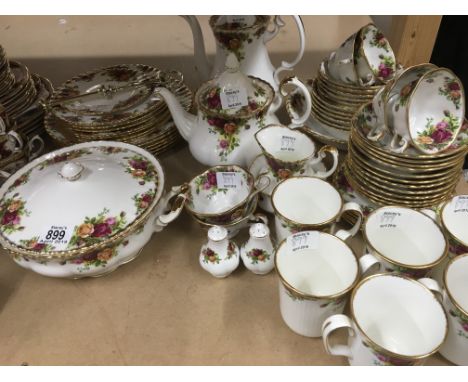 A Royal Albert Country rose dinner/ tea service comprising cups sauces tea plates side plates dinner plates mugs cake plate t