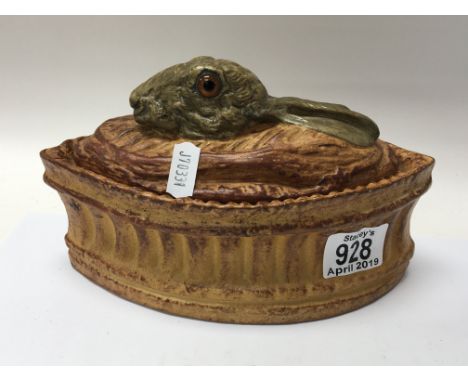 An Early 20th century ceramic French dish and cover the top with a raised Hare head with glass eyes. Length 20cm. no damage o