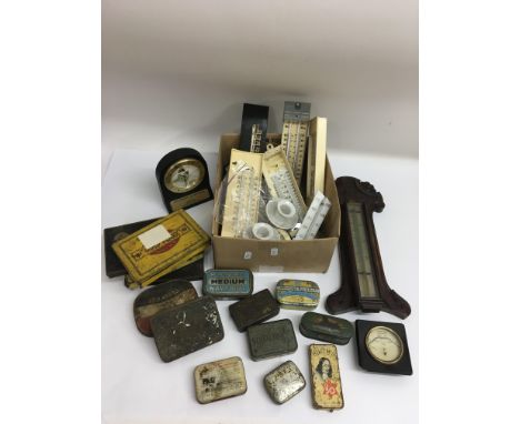 A small collection of old barometer parts and tins