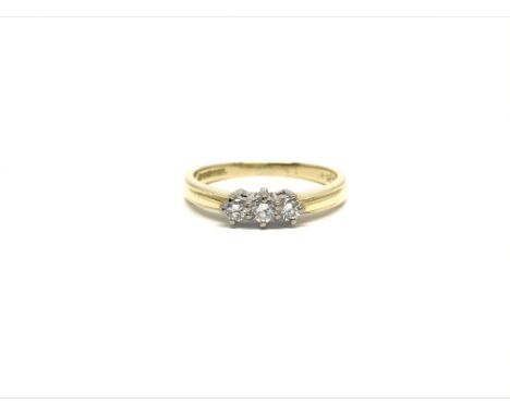 An 18ct yellow gold ring set with a row of three diamonds, approx 0.20ct total, ring size M, total weight 2.9 grams.