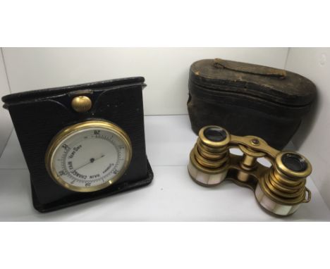 A leather cased travel barometer and a pair of Desse Mother of Pearl opera glasses