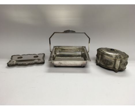 An Art Deco silver plated fruit dish with a handle, a silver plated inkwell stand and a silver plated jewellery box.