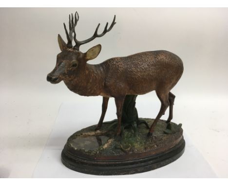 A well detailed , continental painted spelter model of a stag on naturalistic base.Approx 32x 38cm long, impressed marks.