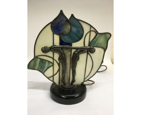 An Art Deco type lamp formed as stylised female figures supporting a glass panel