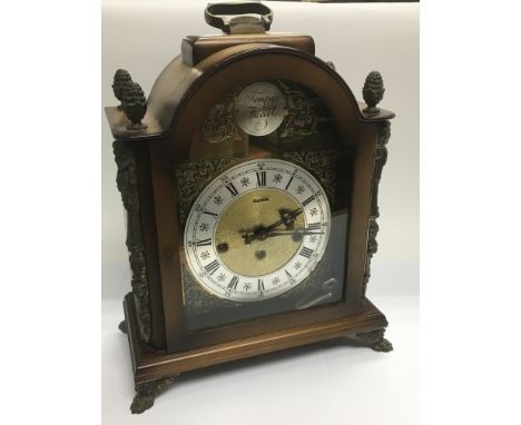 A German Franz Hermle mahogany clock with silvered chapter ring and metal mounts, approx 39cm.