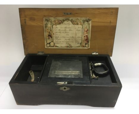A mahogany music box playing eight airs, approx 37cm x 12cm x 19cm.