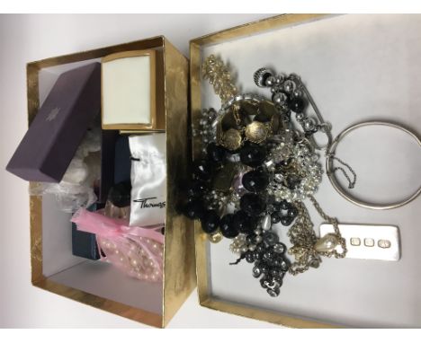 A box of costume jewellery including a silver pendant and bangle