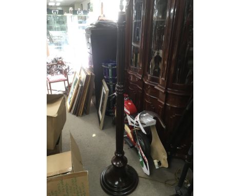 A carved mahogany standard lamp.