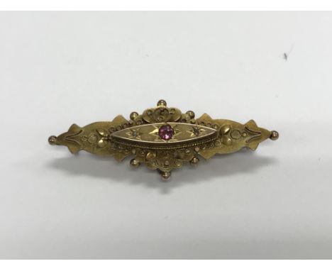 A Edwardian gold brooch inset with a amethyst