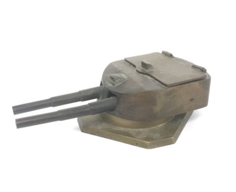 A cast iron inkwell in the form of an anti aircraft turret cast from metal from the German battleship 'Helgoland'.