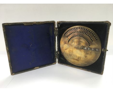 A brass British calculator, model B, housed in a leather case.