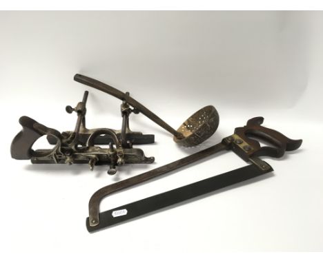 A Victorian metal number 45 plane, a Victorian T Williams Smithfield metal saw and a horn ladle.