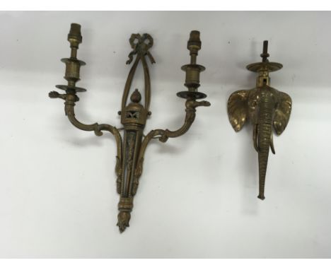A vintage brass wall light and unusual brass elephant door knocker.