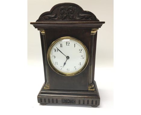 An Edwardian Mahogany Mantel clock with a white enamel dial. Height 24.5cm