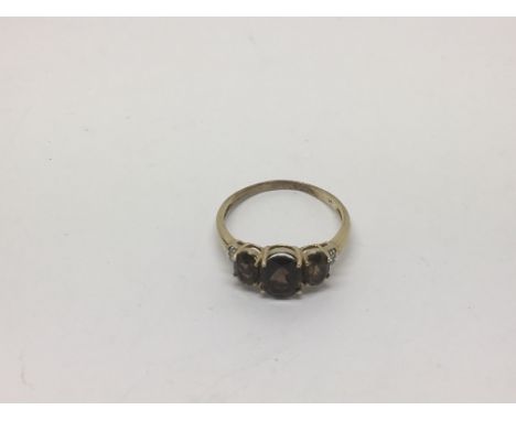 A 9ct gold ring set with smoked quatz and small diamonds, approx size R and approx 2.4g.