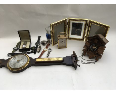 A box containing a collection of watches and clocks and also a barometer.
