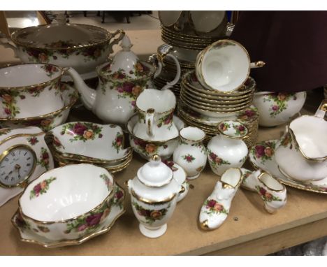 A Royal Albert Country rose dinner/ tea service comprising cups, sauces side plates, tea pot, milk jug, sugar bowl, tureens, 