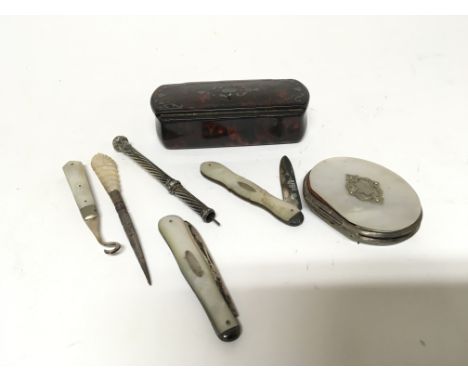 A collection of silver and mother of pearl knifes a snuff box and a small mother of pearl purse.