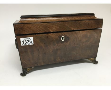 A George III Mahogany tea caddy with glass liner and and boxes. With gilt metal mounts.