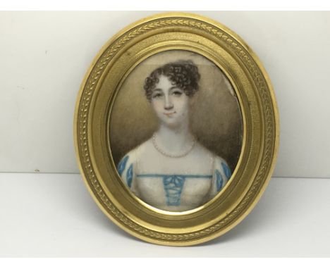 An oval framed miniature portrait of a young lady, approx 11cm x 10cm.