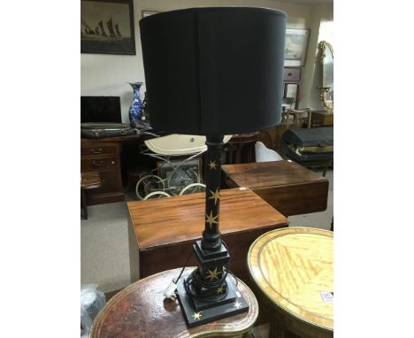 A Regency style table lamp painted black and iverlaid with giltwork stars, approx total height 87cm.