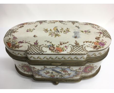 A continental ceramic jewellery casket decorated with birds and gilding.Approx 30x15cm