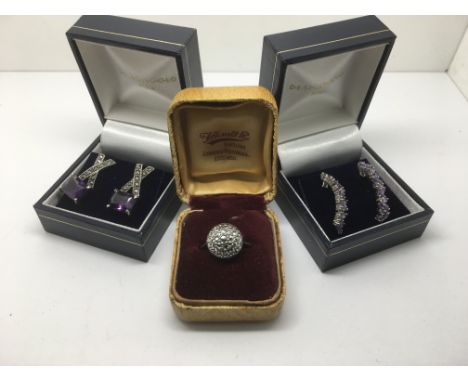 A pair of silver earrings set with amethyst type stones and a marcasite ring (3).