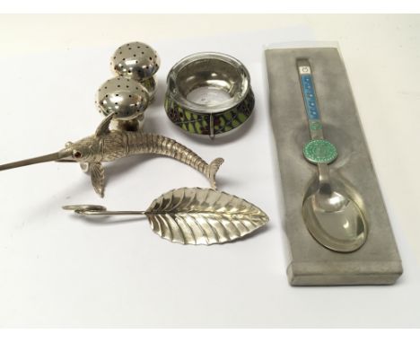 A collection of white metal and silver oddments comprising a Danish Silver A Michelsen Spoon an enamel salut cellar silver mu