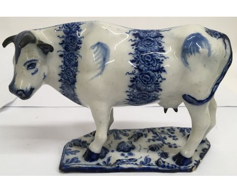 A Delft model of of a cow, the base applied with insects, possibly late 18th century.Approx 24cmx 14cm high, some restoration