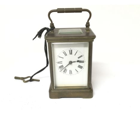 A brass cased carriage clock with key. glasss A/f.