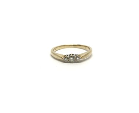 A 9ct gold ring set with a row of three diamonds, ring size approx Q, total weight approx 2.3 grams.