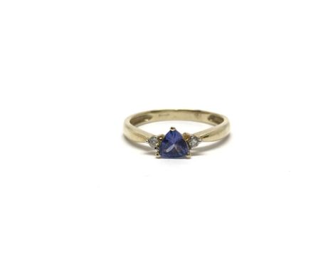 A 9ct gold ring set with a central tanzanite flanked by a diamond either side, ring size approx N/O, total weight approx 1.5 