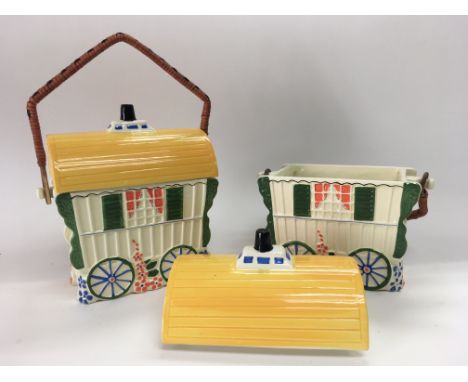 A pair of Old Romany ceramic caravan, presumably biscuit bins. Standing approx 21cm.