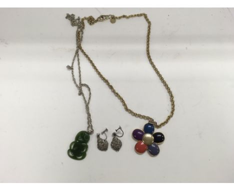 A Mark Jacobs necklace with a 9ct chain and pendant, a pair of Silver and Marcasite earrings and a jade pendant on a silver c