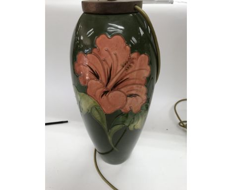 A moorcroft table lamp on a green ground decorated with lily 39 cm