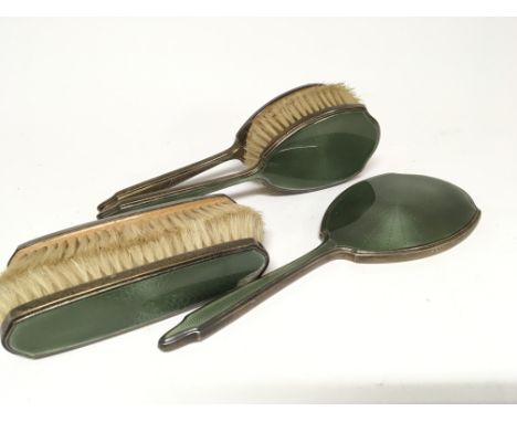 A Green Silver and enamel dressing table set comprising two pairs of brushes and a mirror (5)