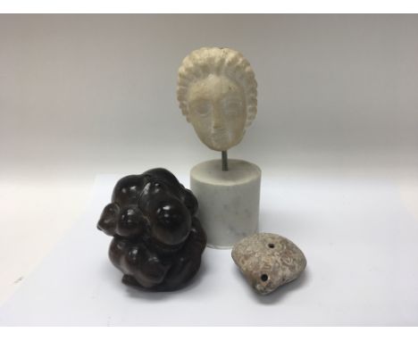 A carved Antiquity small marble type head an Egyptian oil light and a carved hardwood figure. (3)