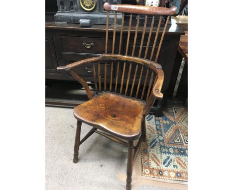 An Early 19th Century Elm Windsor comb back chair