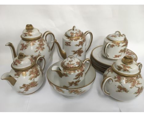 An Oriental tea and coffee service with floral and giltwork decoration on a white ground.