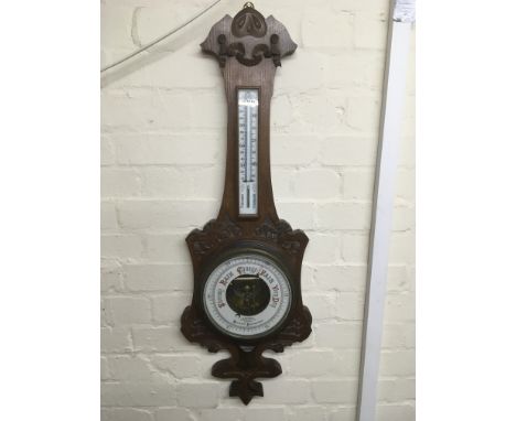 An oak cased barometer, circa 1875, by Maurice Aronsberg.