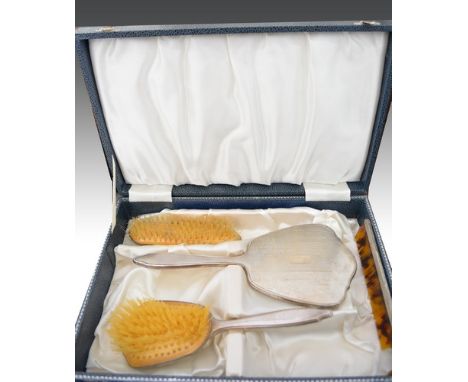 Four piece silver back dressing table set, Birmingham 1964, engine turned decoration including a hand mirror, 25cm, cased.