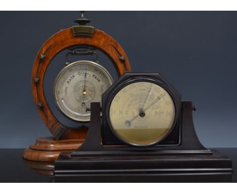 Brass cased aneroid barometer, cylindrical case on an oak horseshoe stand, 30cm and an American Bakelite barometer by Taylor 