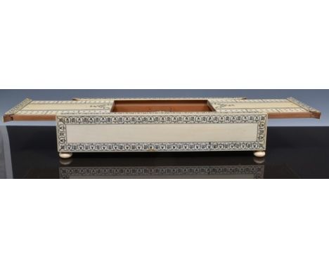 Anglo/Indian ivory cribbage box, oblong form with a sliding section, sandalwood interior, decorated with flower motifs and gu