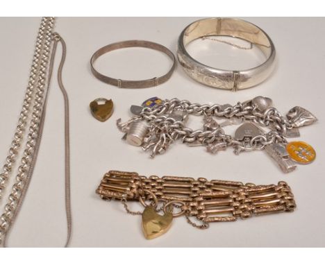 Silver hinged bangle, half engraved, a white metal bangle, a white metal long chain, a white metal charm bracelet, a gilt gat